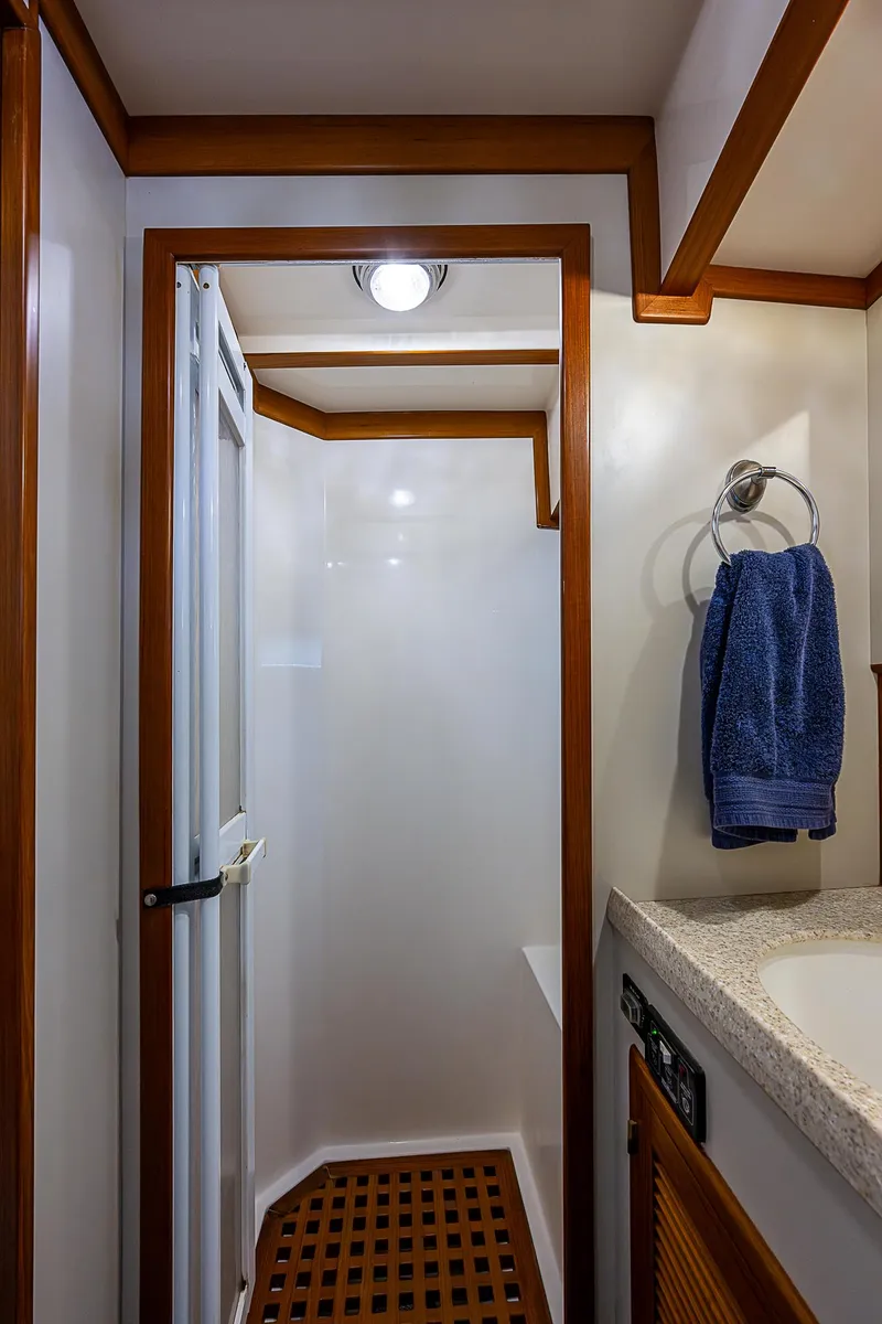 Slide: The Image of 2004 Kadey-Krogen Krogen North Sea yacht bathroom with shower and wooden accents. - 26