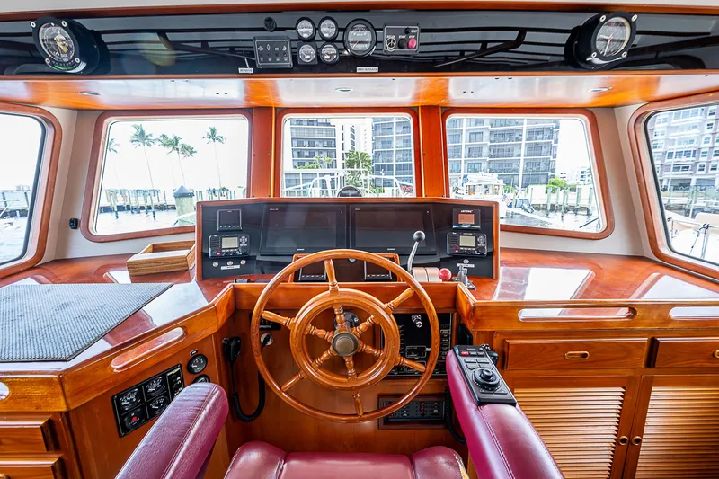 Slide: The Image of Pilothouse of 2004 Kadey-Krogen Krogen North Sea yacht with wooden steering wheel and navigation instruments. - 29