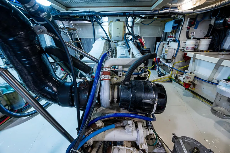 Slide: The Image of Engine room of 2004 Kadey-Krogen Krogen North Sea yacht, showcasing complex machinery and piping. - 34