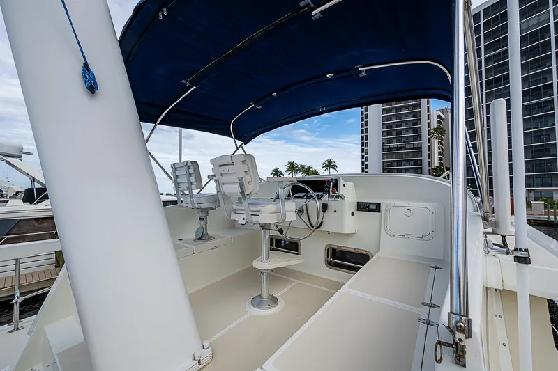 Slide: The Image of 2004 Kadey-Krogen Krogen North Sea yacht helm with blue canopy and modern controls. - 42