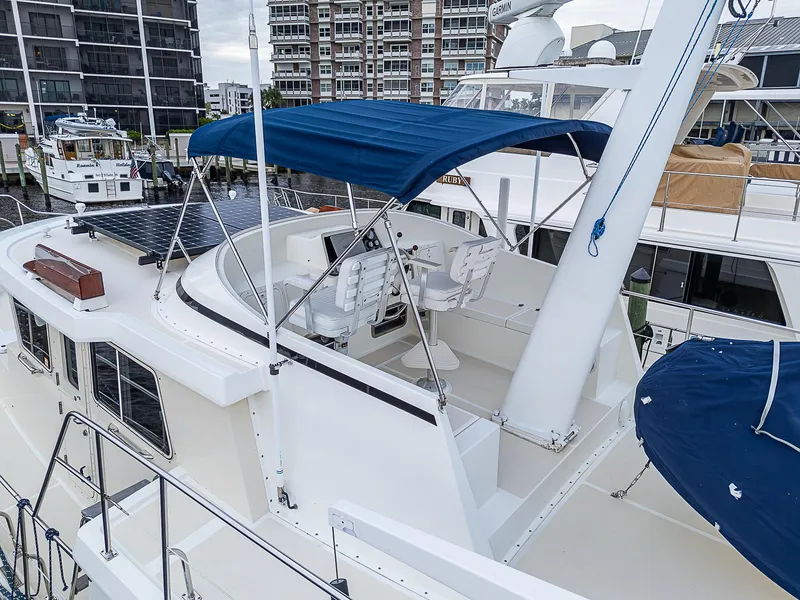 Slide: The Image of 2004 Kadey-Krogen Krogen North Sea yacht with blue canopy docked at marina. - 47