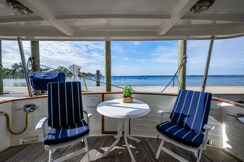 Slide: The Image of 2004 Kadey-Krogen Krogen North Sea yacht deck with chairs, table, and ocean view. - 5