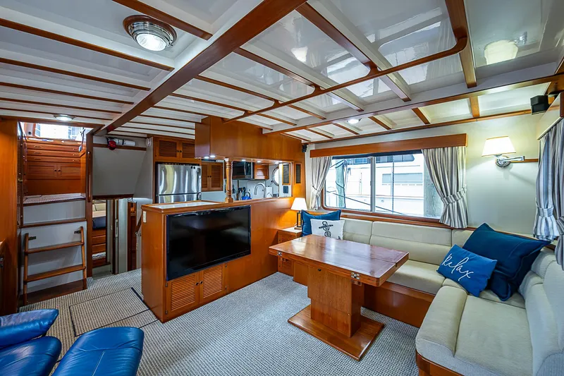 Slide: The Image of Luxurious 2004 Kadey-Krogen North Sea yacht interior with wood finishes and cozy seating area. - 9
