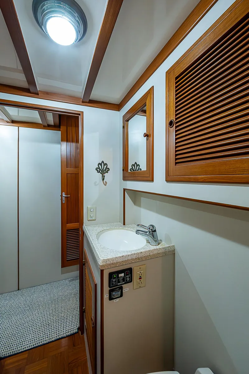Slide: The Image of 2004 Kadey-Krogen Krogen North Sea yacht bathroom with wooden accents and compact sink. - 21