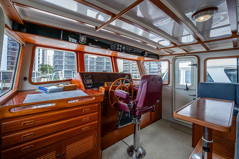 Slide: The Image of Pilothouse interior of 2004 Kadey-Krogen Krogen North Sea yacht with wooden helm and seating. - 32