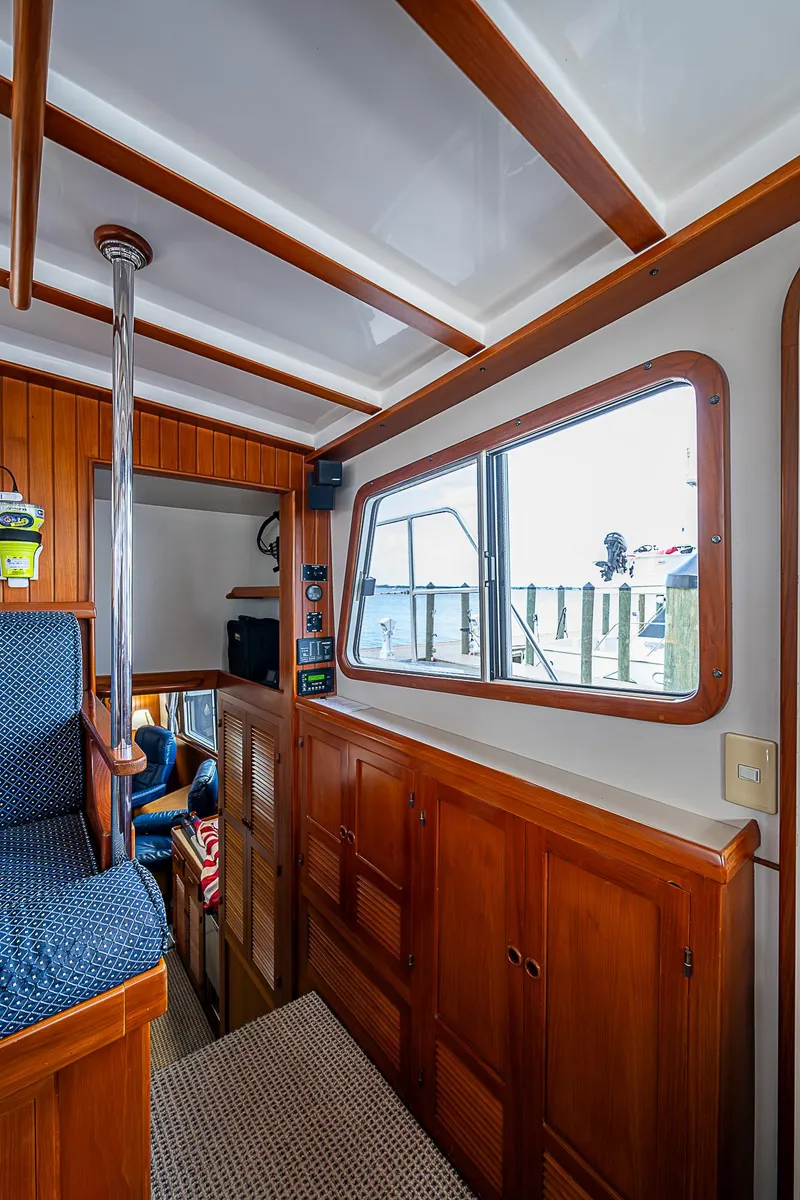 Slide: The Image of 2004 Kadey-Krogen Krogen North Sea interior with wood paneling and large window. - 33