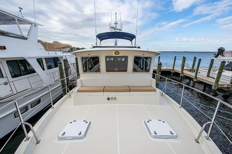Slide: The Image of 2004 Kadey-Krogen Krogen North Sea yacht docked at marina, clear sky, calm water. - 39