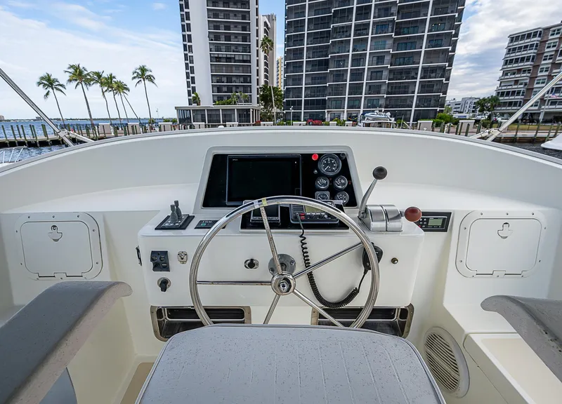 Slide: The Image of Helm of 2004 Kadey-Krogen Krogen North Sea yacht with modern controls and cityscape backdrop. - 43