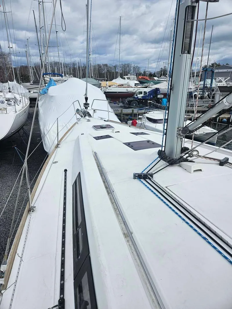 Slide: The Image of 2012 Beneteau Oceanis 41 sailboat on land, marina background, overcast sky. - 10