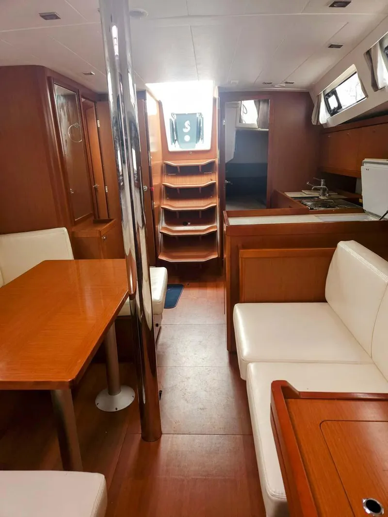 Slide: The Image of Interior of 2012 Beneteau Oceanis 41 sailboat with wood finish and seating area. - 18
