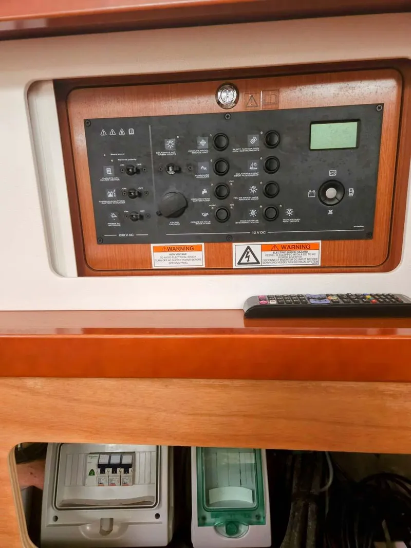 Slide: The Image of Control panel of 2012 Beneteau Oceanis 41 sailboat, featuring various switches and dials. - 20