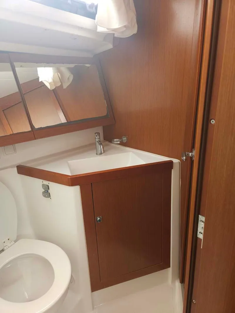 Slide: The Image of 2012 Beneteau Oceanis 41 yacht bathroom with wood cabinetry and modern fixtures. - 26