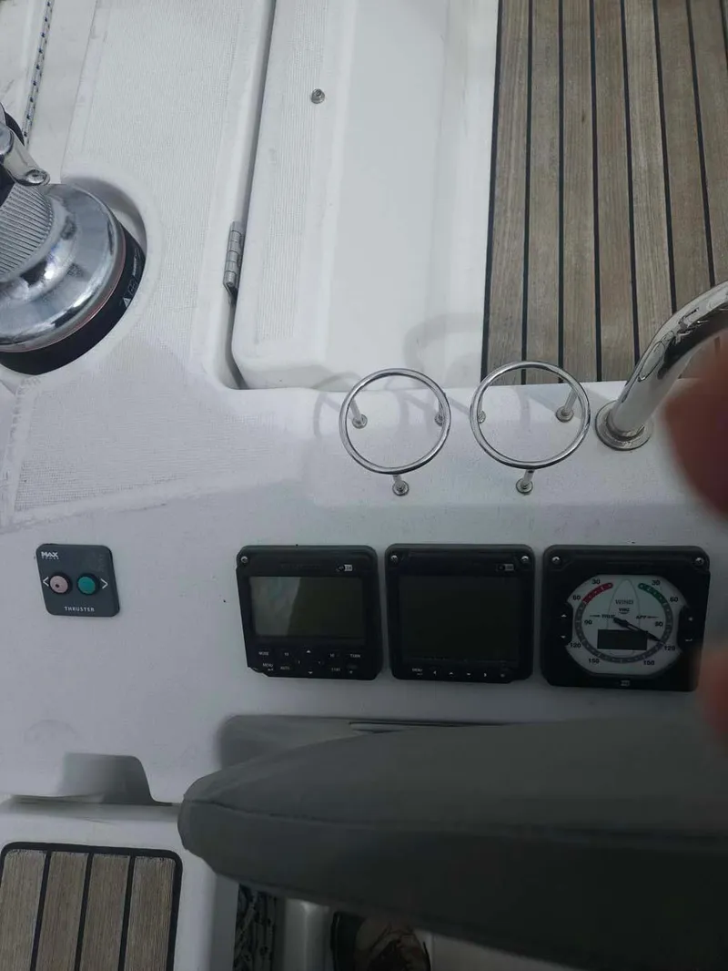 Slide: The Image of Beneteau Oceanis 41 cockpit controls, 2012 model, featuring navigation instruments and teak decking. - 3