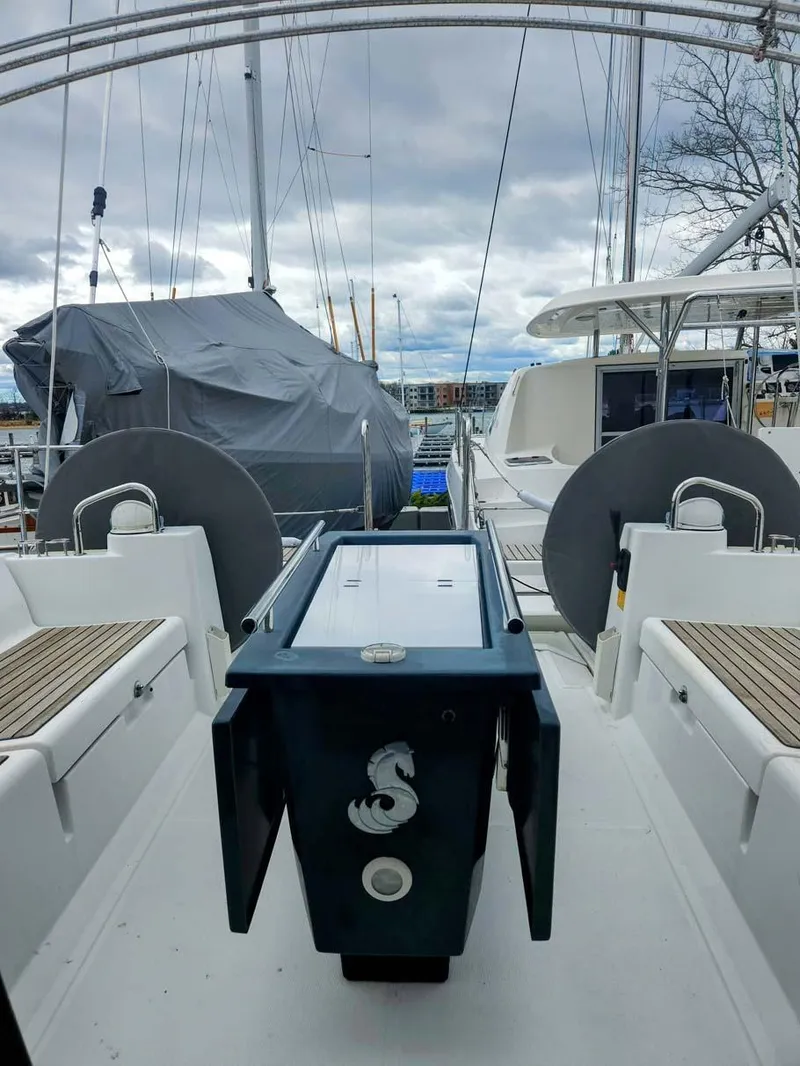 Slide: The Image of 2012 Beneteau Oceanis 41 sailboat deck with dual steering wheels and covered equipment. - 5