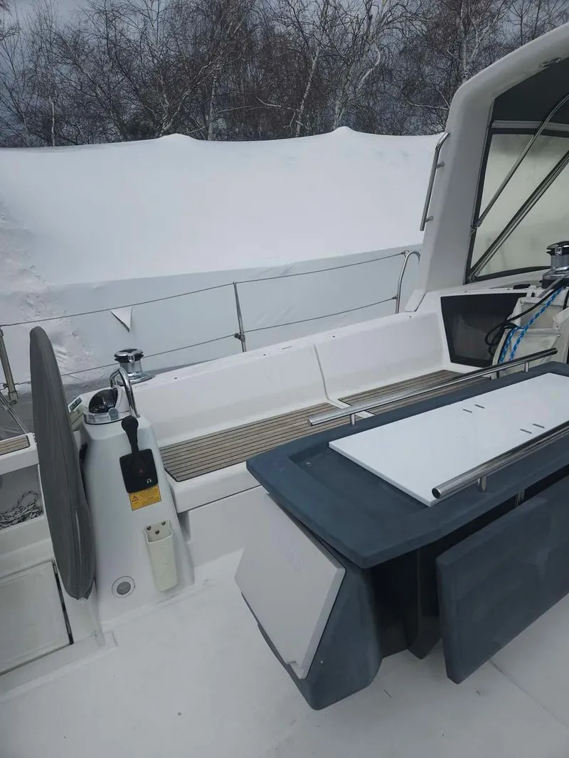 Slide: The Image of 2012 Beneteau Oceanis 41 sailboat cockpit with covered seating and steering wheel. - 7