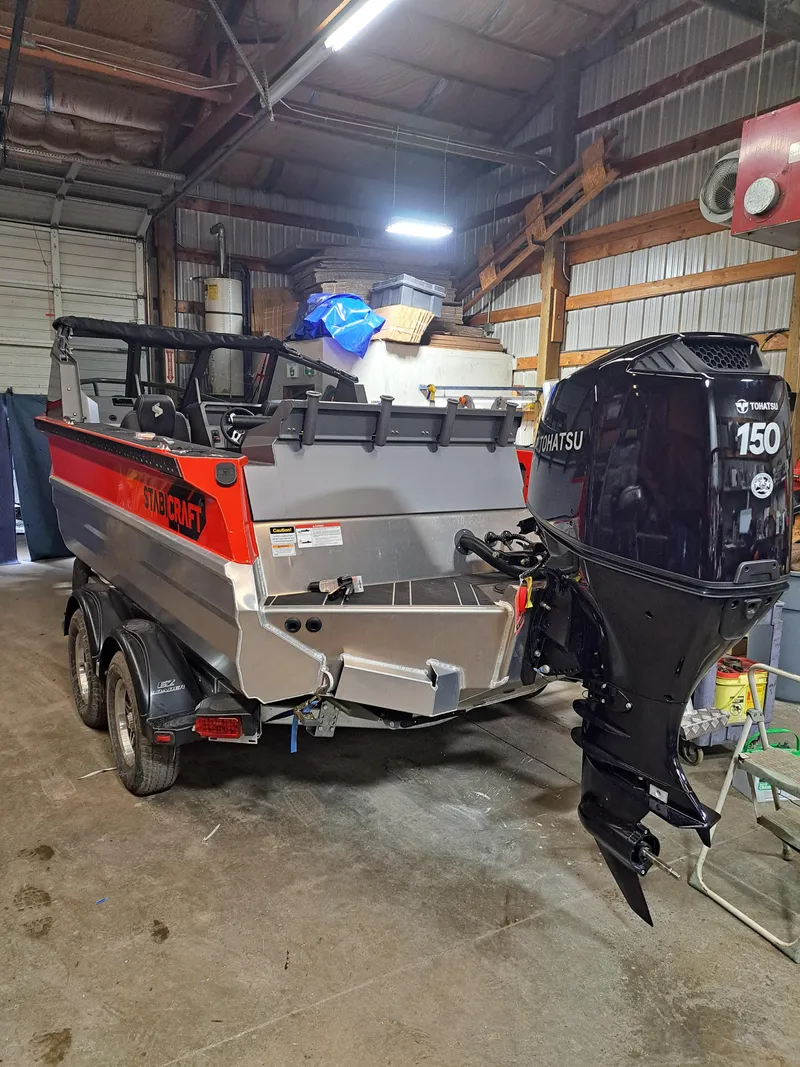 The Image of 2024 Stabicraft Treker Profish boat with Tohatsu 150 engine in a garage. - 0