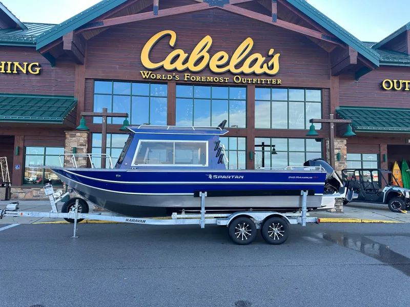 The Image of 2025 Spartan 240 Maximus Pro boat on trailer outside Cabela's store. - 0