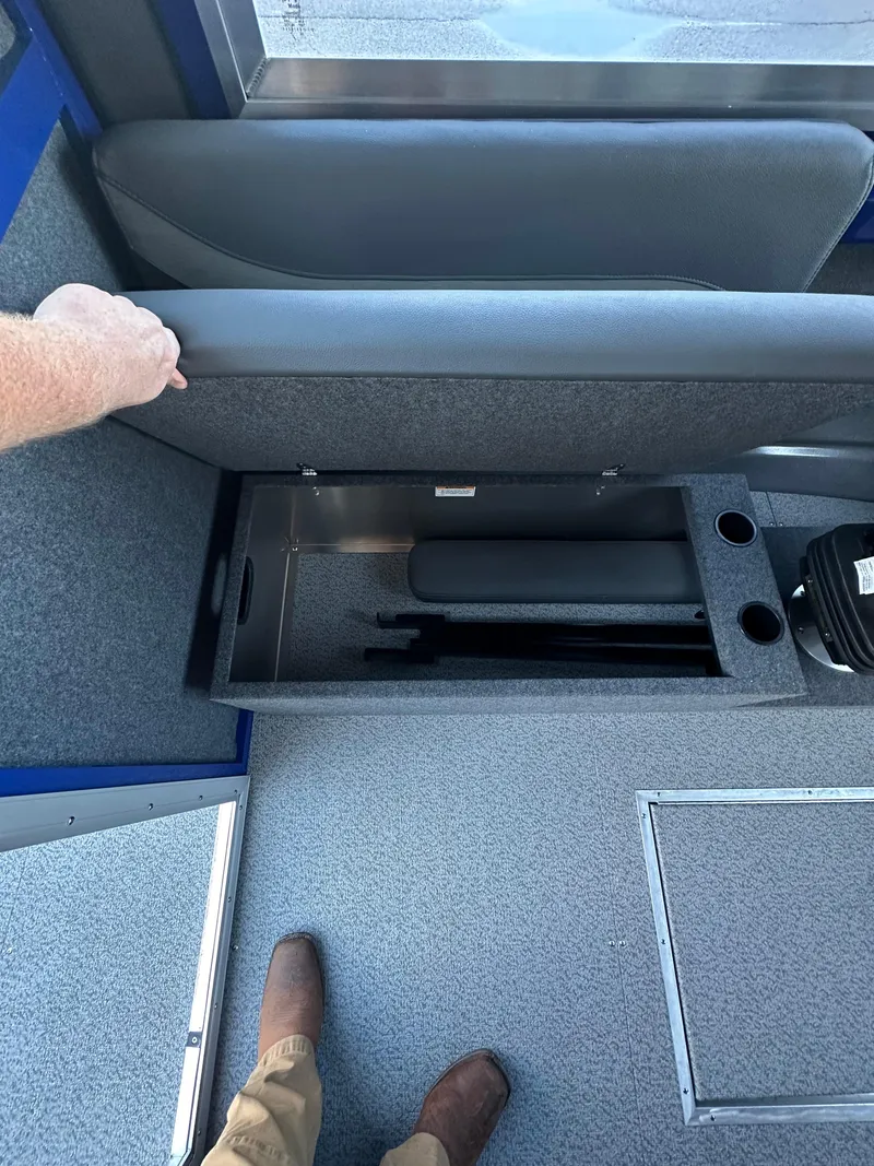 Slide: The Image of 2025 Spartan 240 Maximus Pro interior storage compartment with seat lifted. - 12