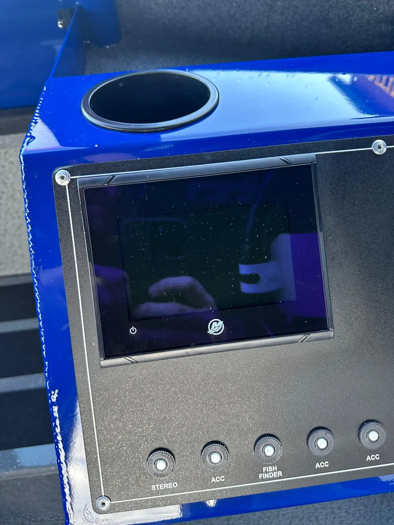 Slide: The Image of Control panel of 2025 Spartan 240 Maximus Pro with cup holder and display screen. - 17