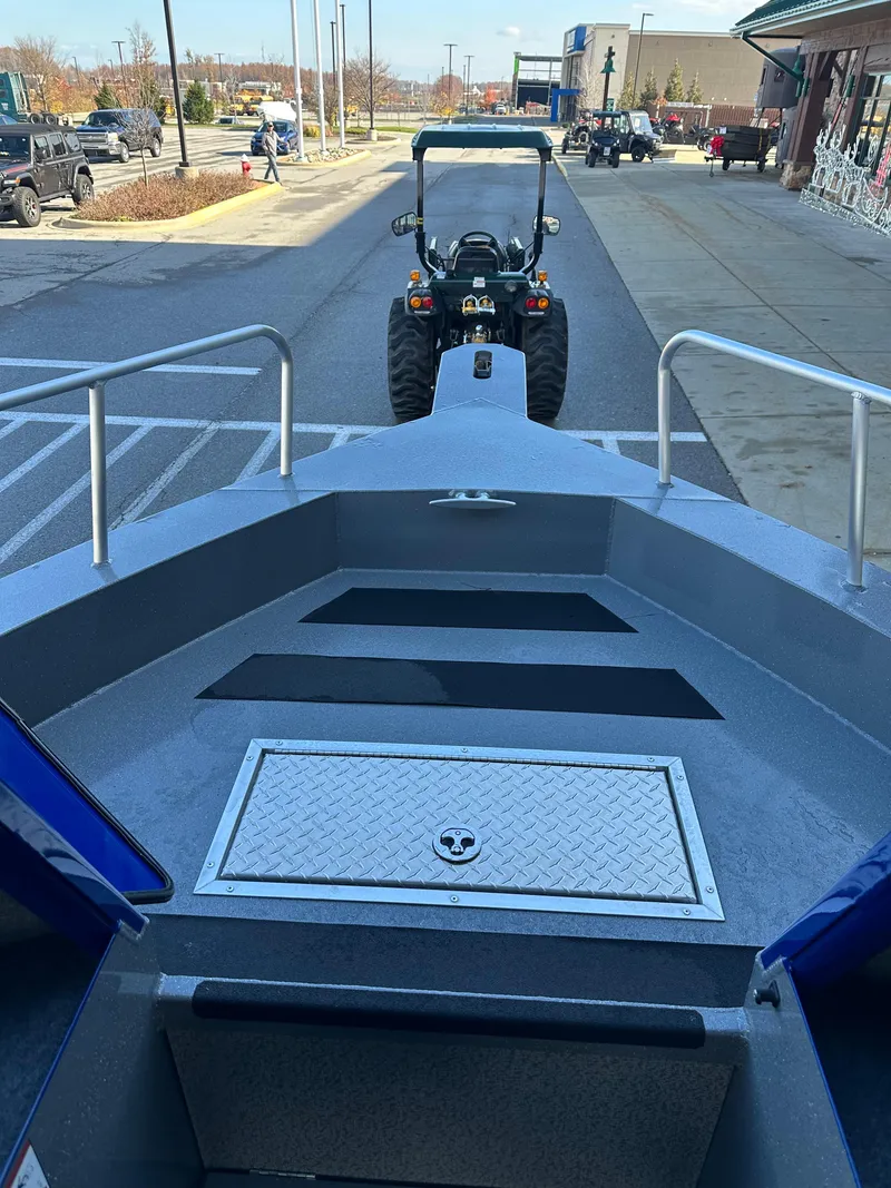 Slide: The Image of 2025 Spartan 240 Maximus Pro boat on trailer, parked in urban area. - 18