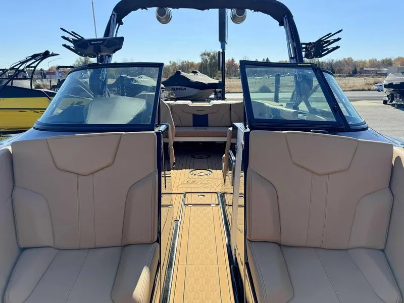 Slide: The Image of 2024 MasterCraft XT23 boat interior with tan seating and open cockpit view. - 13