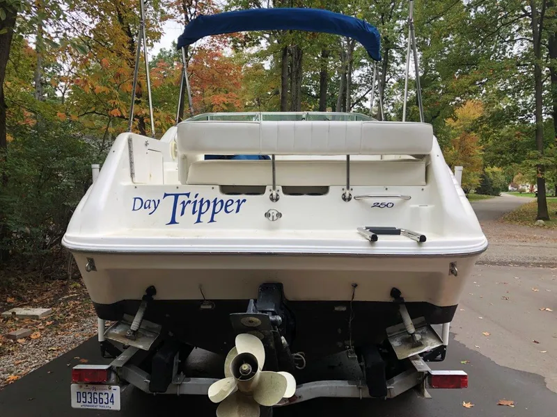 Slide: The Image of 1996 Sea Ray 250 Sundancer boat with "Day Tripper" name, parked on a trailer. - 7