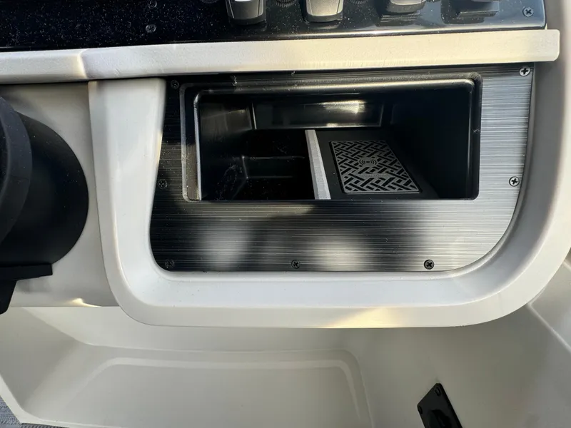 Slide: The Image of Dashboard compartment of 2025 Sweetwater 2286 CSE boat, featuring sleek design and storage space. - 11