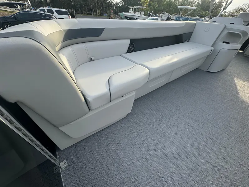 Slide: The Image of 2025 Sweetwater 2286 CSE boat interior with sleek white seating and modern design. - 6