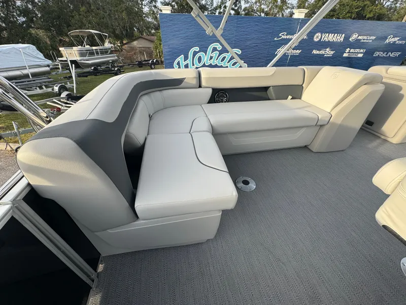 Slide: The Image of 2025 Sweetwater 2286 CSE boat interior with plush seating and modern design. - 7