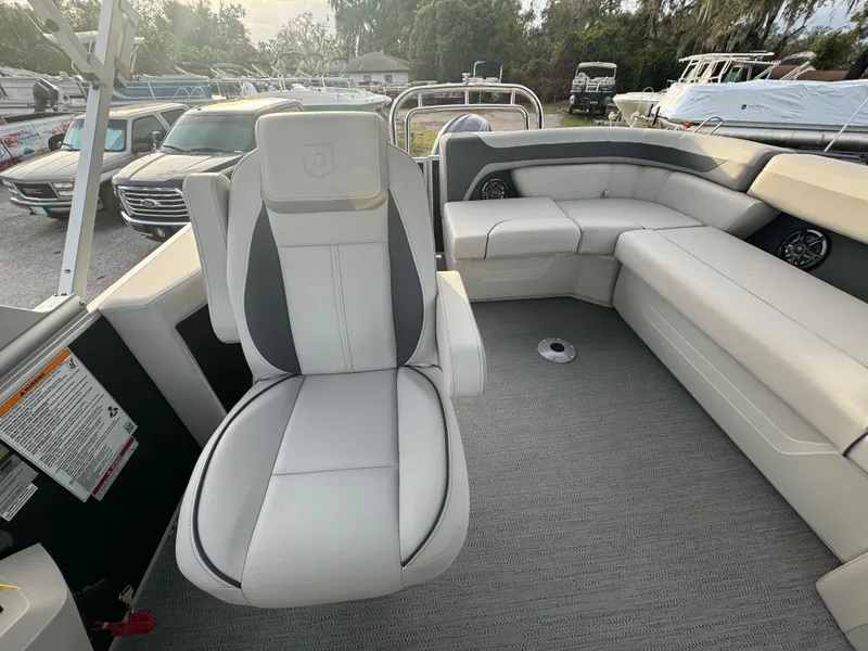 Slide: The Image of 2025 Sweetwater 2286 CSE boat interior with plush seating and modern design. - 9