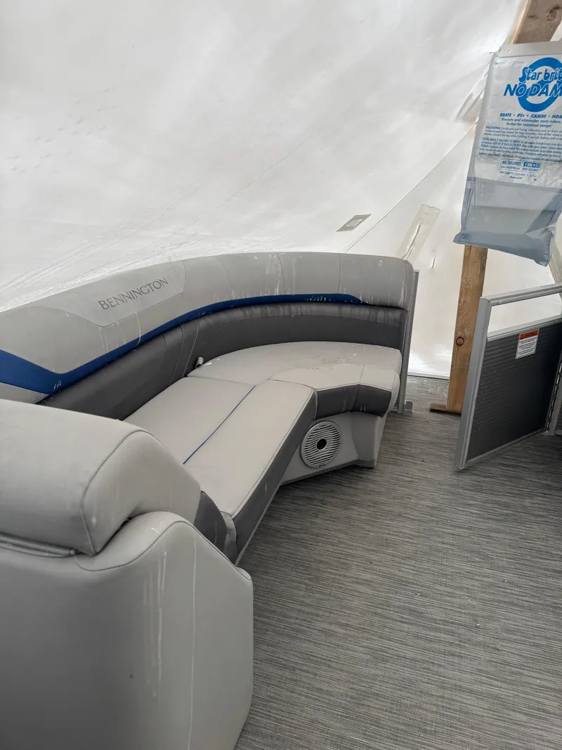 Slide: The Image of 2022 Bennington 23SXSR boat interior with steering wheel and seating. - 2