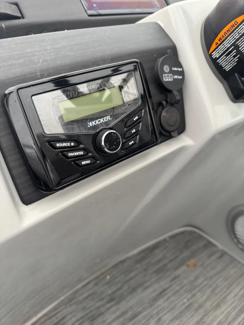 Slide: The Image of 2022 Bennington 23SXSR boat interior with gray seating and blue accents. - 4