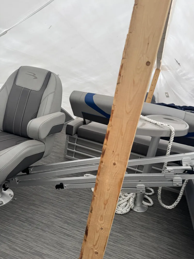 Slide: The Image of 2022 Bennington 23SXSR boat interior with gray seating and carpeted floor. - 5