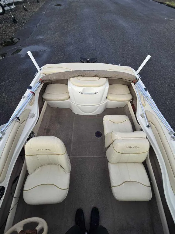 Slide: The Image of 2001 Sea Ray 180 Bow Rider interior with beige seating and spacious layout. - 5