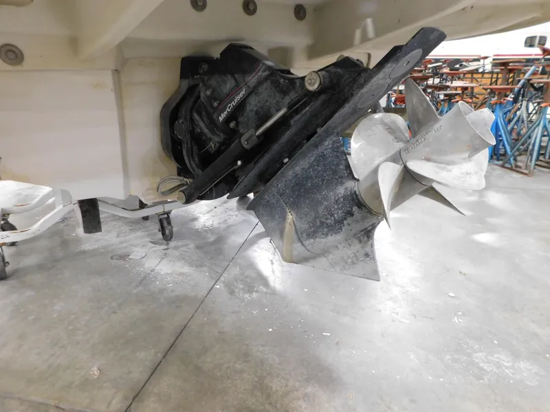 Slide: The Image of 2007 Sea Ray 260 Sundeck boat propeller and stern drive in a garage setting. - 4