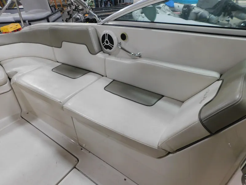 Slide: The Image of 2007 Sea Ray 260 Sundeck interior seating with white and gray upholstery. - 7
