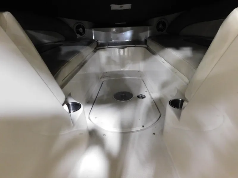 Slide: The Image of Interior of a 2007 Sea Ray 260 Sundeck boat, featuring seating and cup holders. - 9