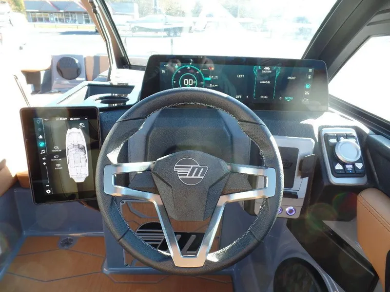 Slide: The Image of 2025 Malibu 23 MXZ dashboard with modern steering wheel and digital displays. - 17