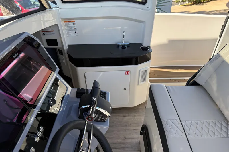 Slide: The Image of Interior of 2025 Navan C30 boat with steering wheel, control panel, and seating area. - 11