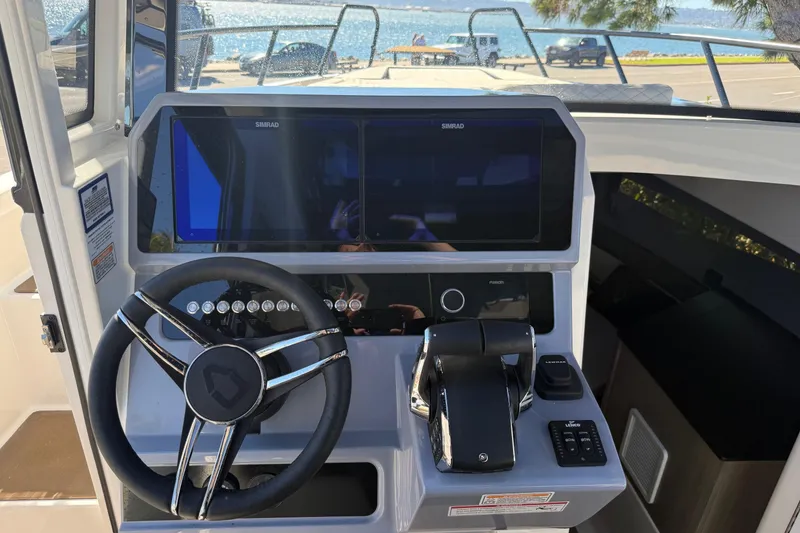 Slide: The Image of 2025 Navan C30 boat dashboard with steering wheel and navigation controls. - 12