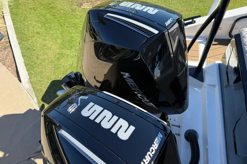 Slide: The Image of Navan C30 2025 boat with dual Mercury outboard engines, docked on a sunny day. - 22