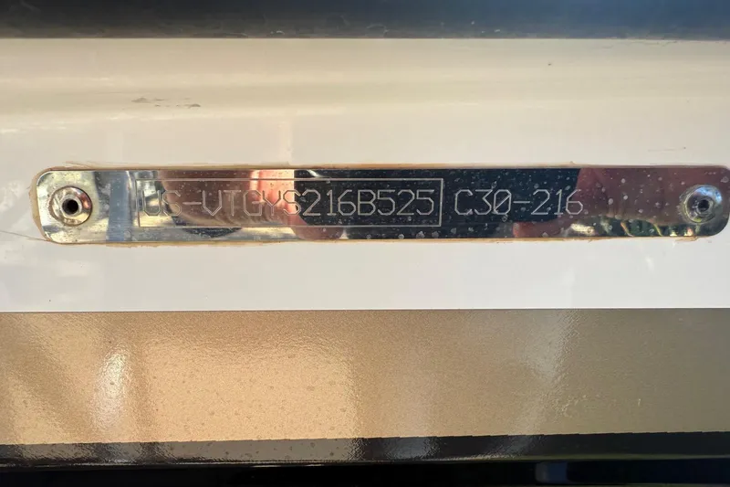 Slide: The Image of Metallic identification plate on Navan C30, 2025 model, with engraved serial number. - 23