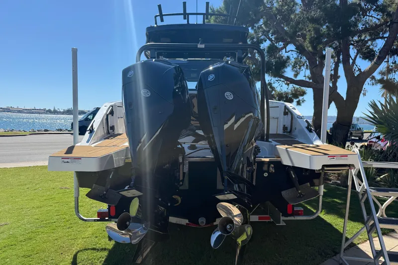 Slide: The Image of 2025 Navan C30 boat with dual outboard motors, parked near a scenic waterfront. - 3