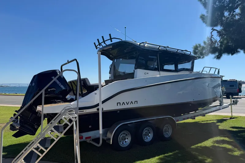 Slide: The Image of 2025 Navan C30 boat on trailer by the waterfront, under clear blue sky. - 4