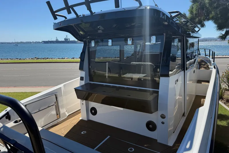 Slide: The Image of Navan C30 2025 boat docked by the waterfront, showcasing sleek design and spacious deck. - 5