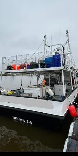 Slide: The Image of Commercial LL Ice Trawler, 1978 model, docked with equipment and crates on deck. - 2