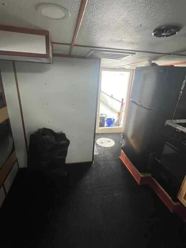 Slide: The Image of Interior of a 1978 Commercial LL Ice Trawler, featuring kitchen and storage area. - 6