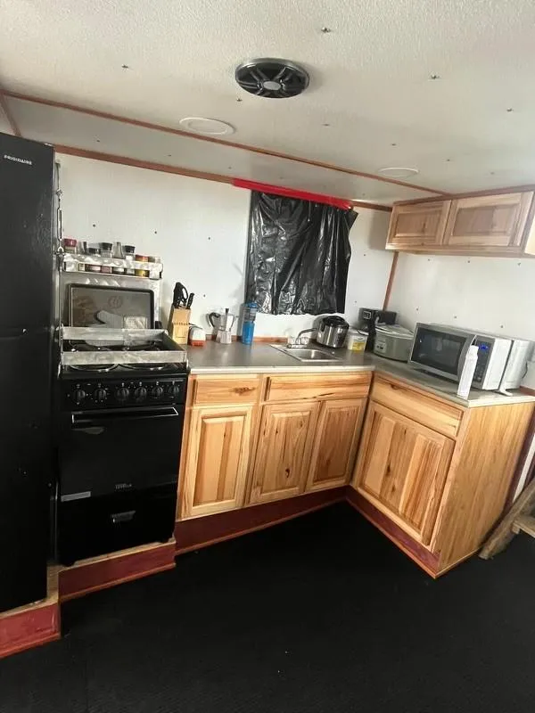 Slide: The Image of 1978 Commercial LL Ice Trawler kitchen with wooden cabinets and modern appliances. - 7
