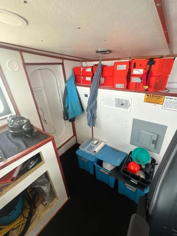 Slide: The Image of Interior of a 1978 Commercial LL Ice Trawler with storage bins and safety equipment. - 8