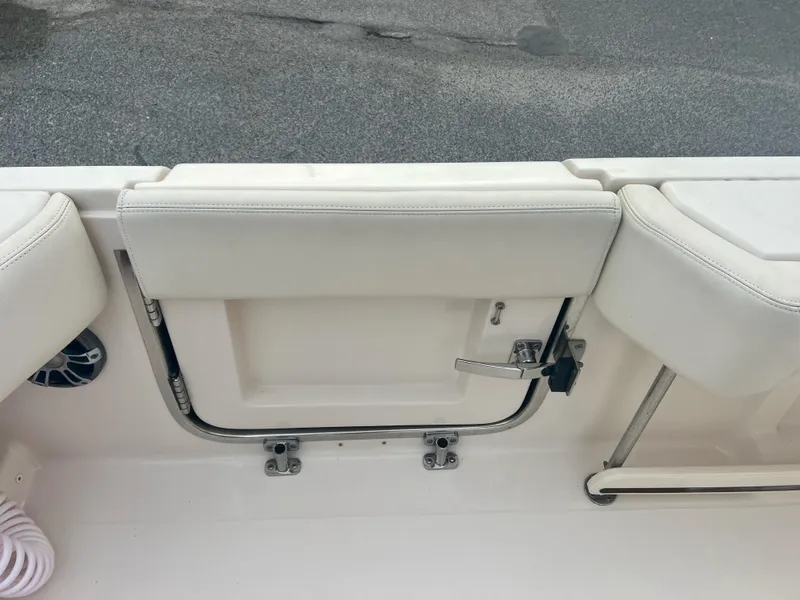 Slide: The Image of Grady-White Canyon 376 boat seating area, 2022 model, featuring white cushioned seats. - 24